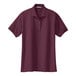 A maroon Port Authority women's polo shirt with short sleeves.