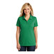 A woman wearing a bright kelly green Port Authority polo shirt with short sleeves.