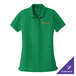 A women's bright kelly green Port Authority short sleeve polo shirt with a logo on it.