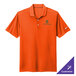 A medium Brilliant Orange Nike Dri-FIT polo shirt with a white Nike swoosh on the sleeve.