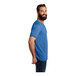A man with a beard wearing an azure blue AllMade T-shirt.
