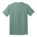A close-up of the back of a light green Port & Company short sleeve t-shirt.