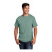 A man smiling and wearing a Port & Company Laurel Green short sleeve t-shirt.