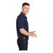 A man wearing a navy Sport-Tek moisture-wicking polo shirt.