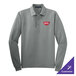 A Cool Gray long sleeve Port Authority polo shirt with a logo on the counter.