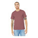 A man wearing a heather mauve Bella Canvas t-shirt and jeans.