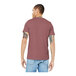 A man wearing a Bella + Canvas heather mauve short sleeve T-shirt.