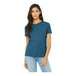 A woman wearing a Bella + Canvas heather deep teal customizable short sleeve T-shirt.