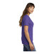 A woman wearing a purple Port & Company short sleeve t-shirt with a v-neck.