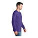 A man wearing a purple Port & Company long sleeve t-shirt.