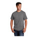 A man wearing a Port & Company medium gray short sleeve T-shirt.