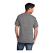 A man wearing a Port & Company medium gray short sleeve t-shirt.