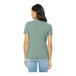 A woman wearing a Bella + Canvas heather prism dusty blue short sleeve t-shirt.