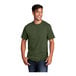 A man wearing a Port & Company olive drab green heather T-shirt.