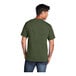 A man wearing a Port & Company Olive Drab Green Heather T-shirt.