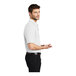 A man wearing a white Port Authority® silk touch polo shirt.