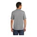 A man wearing a Port & Company unisex athletic heather polo shirt.