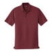 A Port Authority burgundy short sleeve polo shirt.