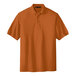 A close-up of an extra small Texas orange Port Authority polo shirt on a white background.