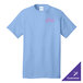 A light blue Port & Company t-shirt with white embroidery of a purple triangle.