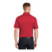 A man wearing a Sport-Tek True Red short sleeve polo shirt.