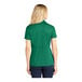 A woman wearing a kelly green Sport-Tek short sleeve polo shirt.