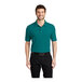 A man wearing a teal green Port Authority silk touch pique polo shirt.