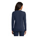 A woman wearing a navy blue Port & Company long sleeve T-shirt.