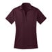 A maroon Port Authority women's polo shirt with a collar.