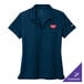 A navy Nike women's polo shirt with a logo on it.