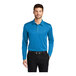 A man wearing a Port Authority Brilliant Blue long sleeve polo shirt with a black collar.