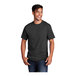 A man wearing a black Port & Company short sleeve t-shirt.