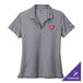 A Nike women's Cool Gray Dri-FIT polo shirt with a logo on the chest.