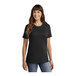 A woman wearing a black Port & Company T-shirt.
