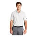 A man wearing a white Nike Dri-Fit polo.