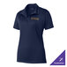 A Sport-Tek navy blue women's polo shirt with a logo on the table.
