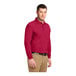 A man wearing a Port Authority red long sleeve polo shirt.