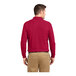 A man wearing a red Port Authority long sleeve polo shirt.