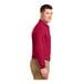 A man wearing a red Port Authority long sleeve polo shirt.