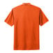 An orange Nike polo shirt with a white collar.