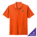 A Nike Dri-FIT orange polo shirt with a white swoosh on the sleeve.