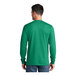 A man wearing a green Port & Company long sleeve shirt.