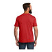 A man wearing a red AllMade Rise-Up t-shirt.
