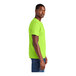 A person wearing a lime green District® T-shirt.