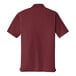 A Port Authority burgundy short sleeve polo shirt.