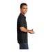 A man wearing a black Port & Company polo shirt.