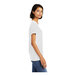 A woman wearing a white District short sleeve T-shirt.
