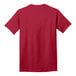 A close-up of a red Port & Company short sleeve T-shirt with a white logo on the front.