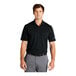 A man wearing a black Nike Dri-Fit polo shirt.
