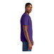 A person wearing a District® purple short sleeve t-shirt.
